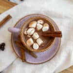 Date latte in a pink mug with marshmallows and cinnamon