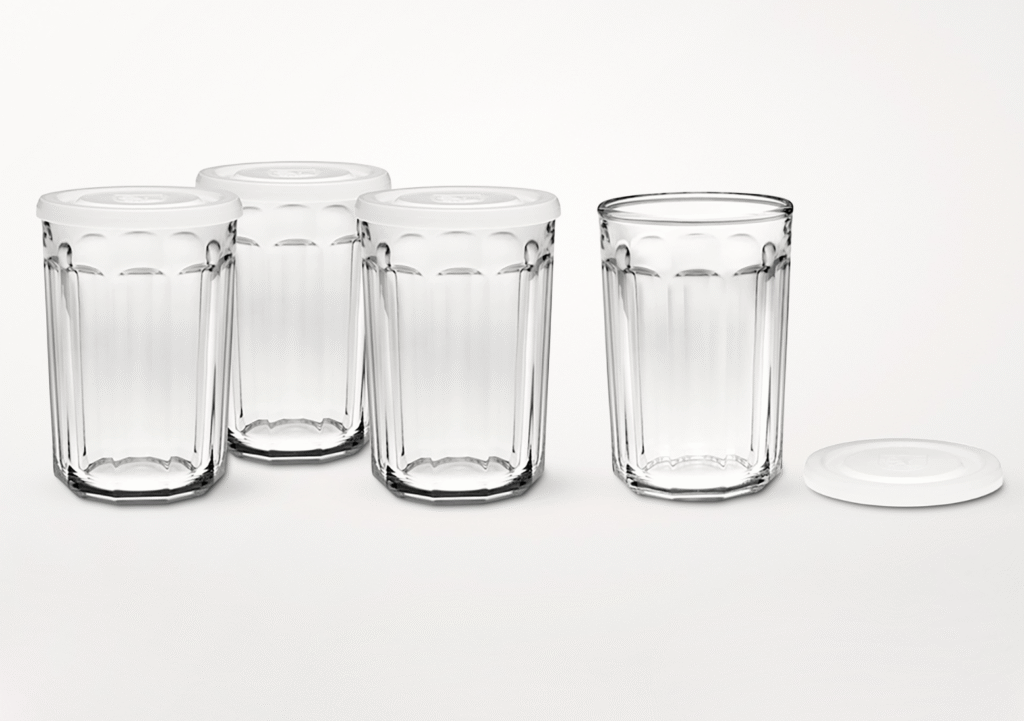 Three glass cups with white lids on and one glass cup with the lid on the side.