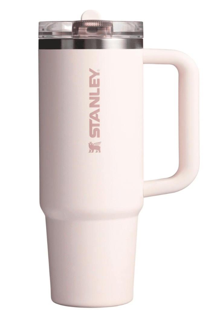 Pink stanley cup with the stanley logo written vertically