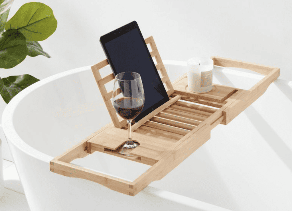 Bath caddy for bath with a glass of wine, candle, and ipad