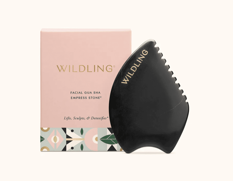 A black gua sha next to the box it comes in with a gold wilding logo.
