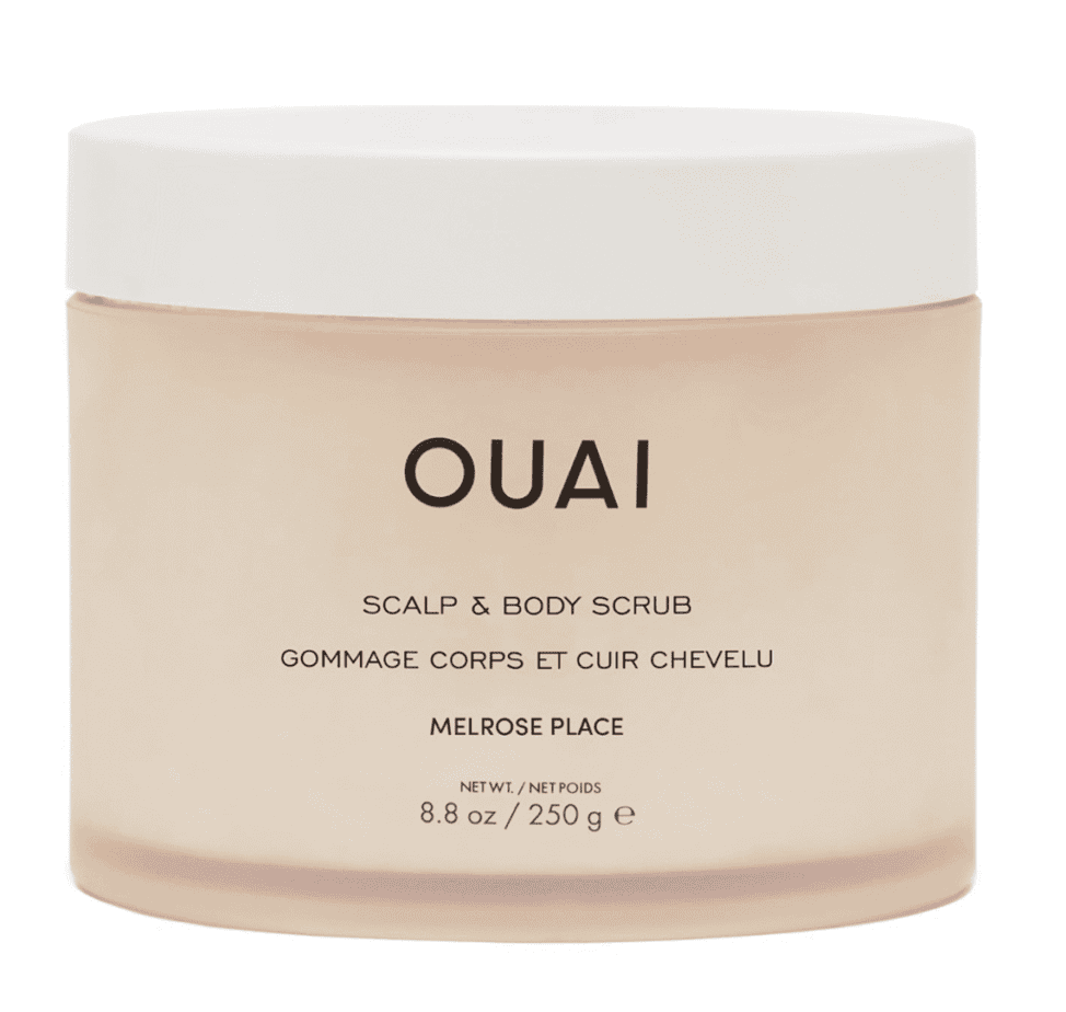 A cream colored scalp scrub with a white lid and black OUAI label