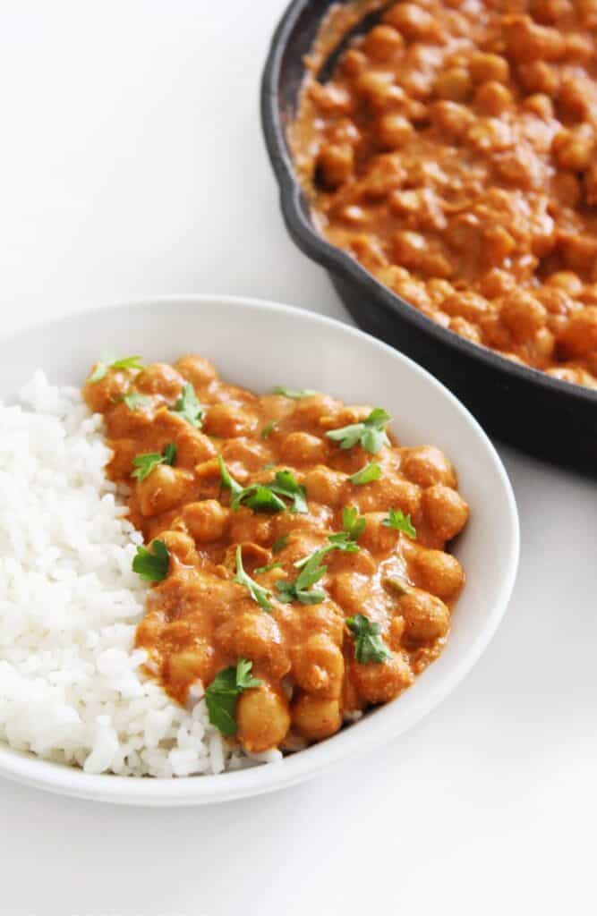 A bowl of vegan butter chickpeas paired with white rice. 