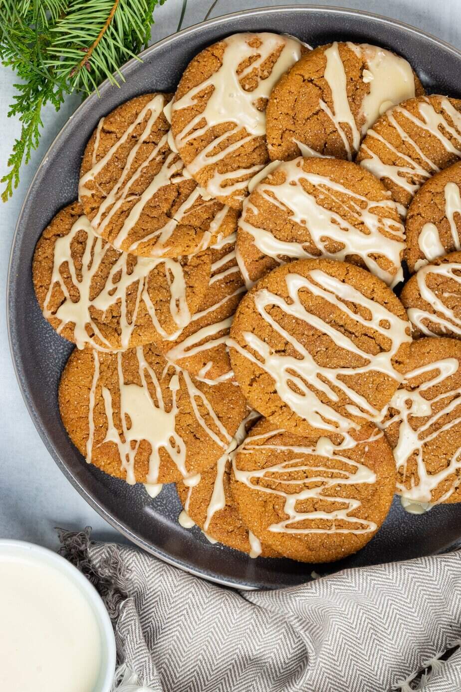 A plate full of ginger cookies with icing.