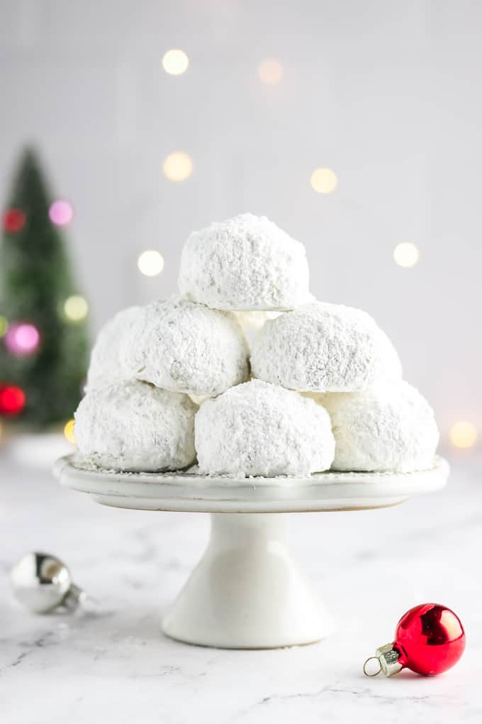 A stack of snowball cookies on a platter