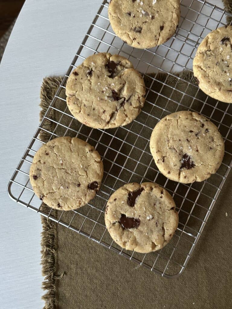 Tahini chocolate chunk cookies on a cooling rack