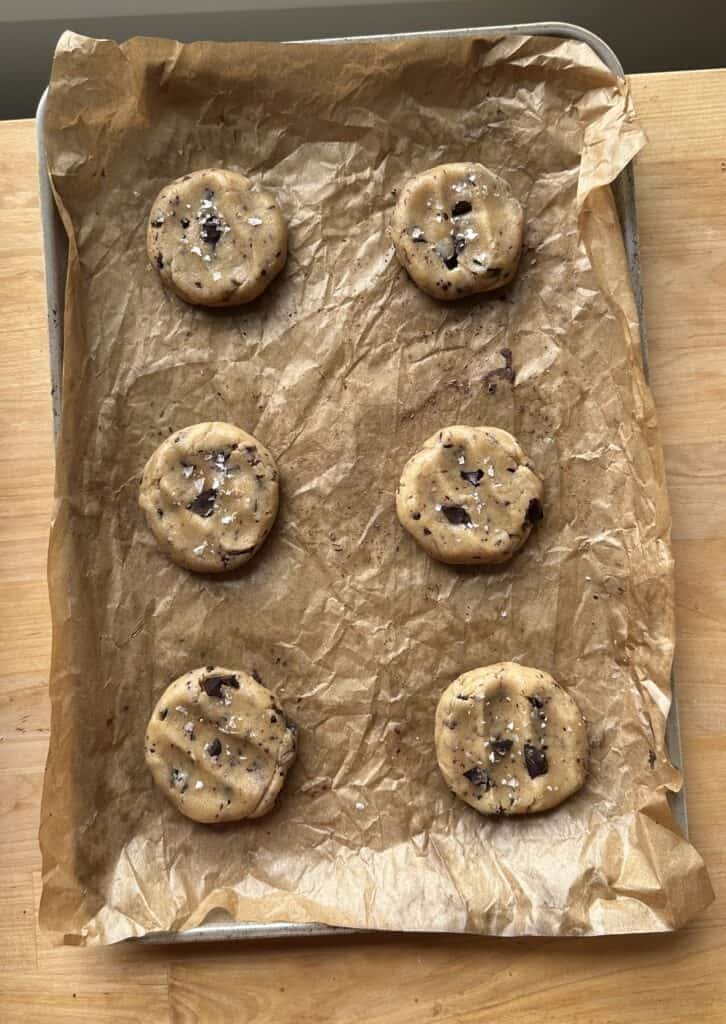 Tahini chocolate chunk cookie dough on a parchment lined baking tray