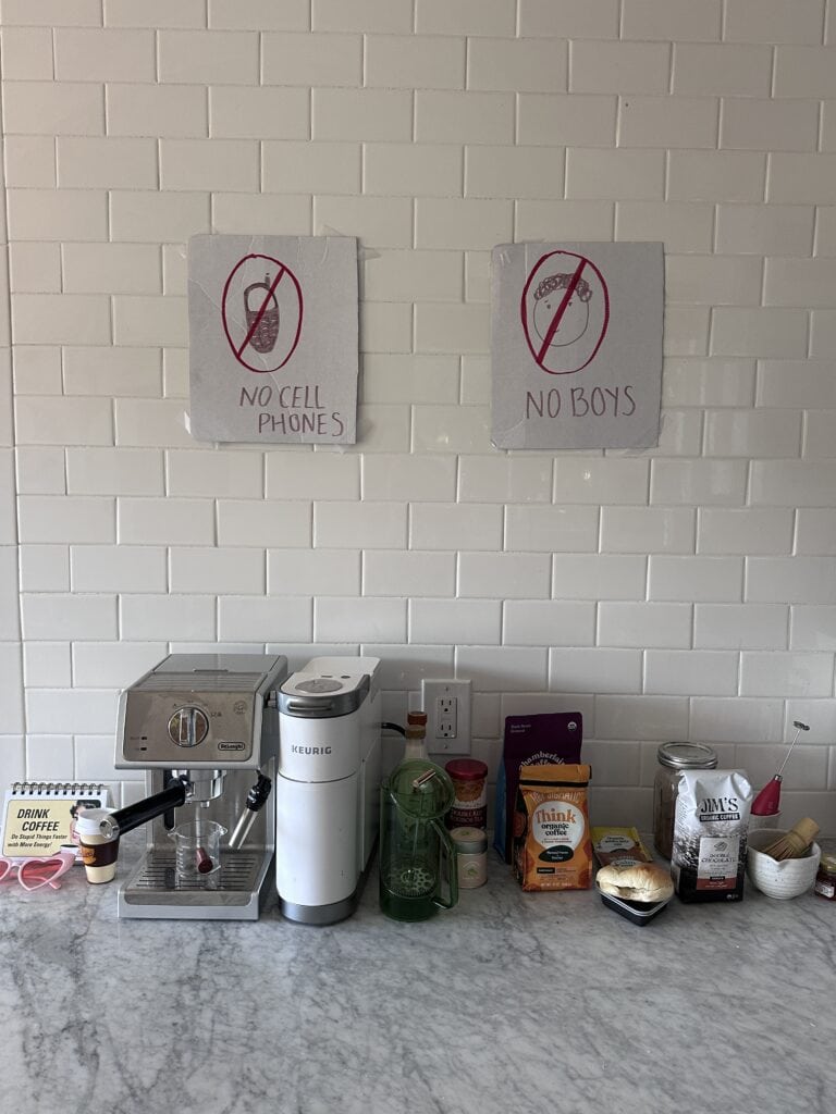 The drink station with gilmore girls and galentines inspired signs, "no cell phones" and "no boys"