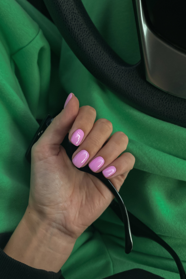 Pink nails with green sweatpants in the background