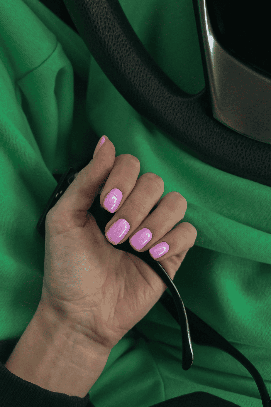 Pink nails with green sweatpants in the background