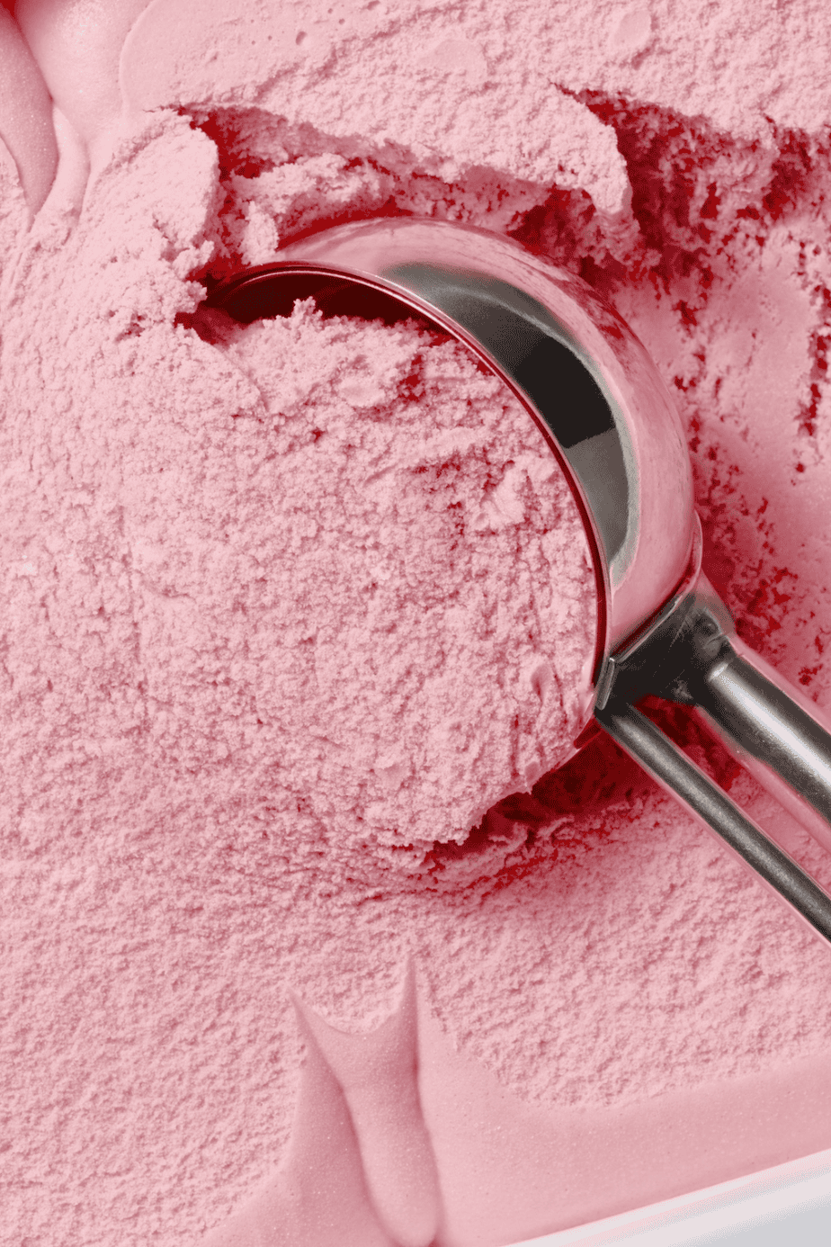 A close up of scooping bright pink ice cream