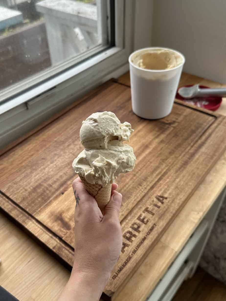 Roasted peach ice cream in a cone.