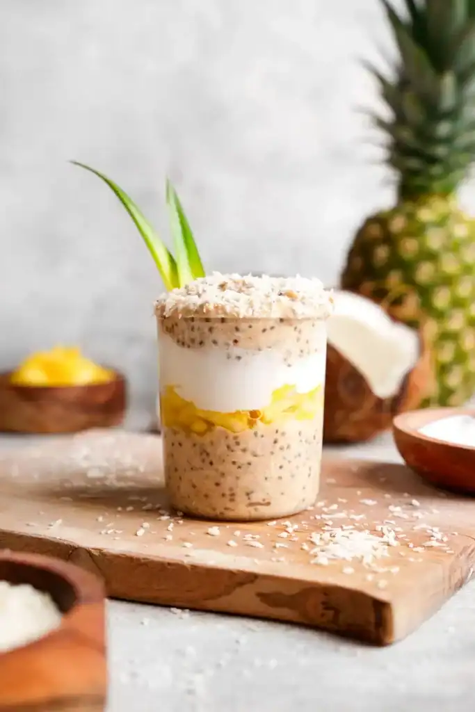 A jar of overnight oats with a layer of pineapple and yogurt.