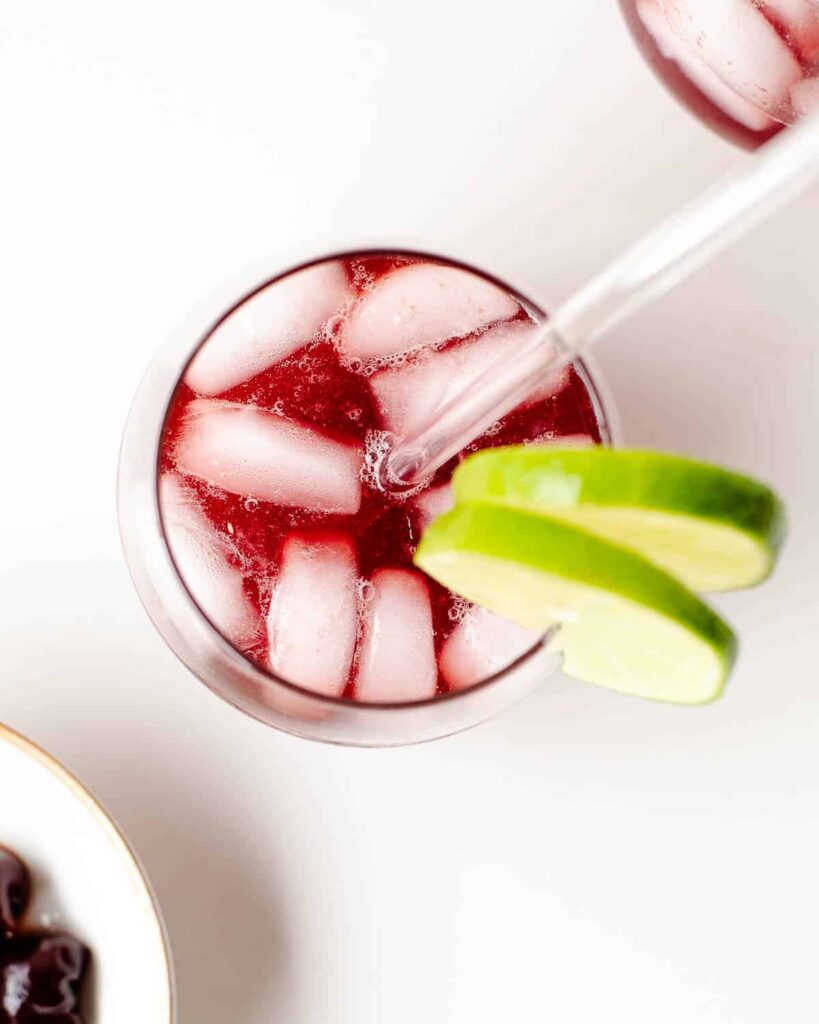 Top down shot of a cherry mocktail garnished with lime
