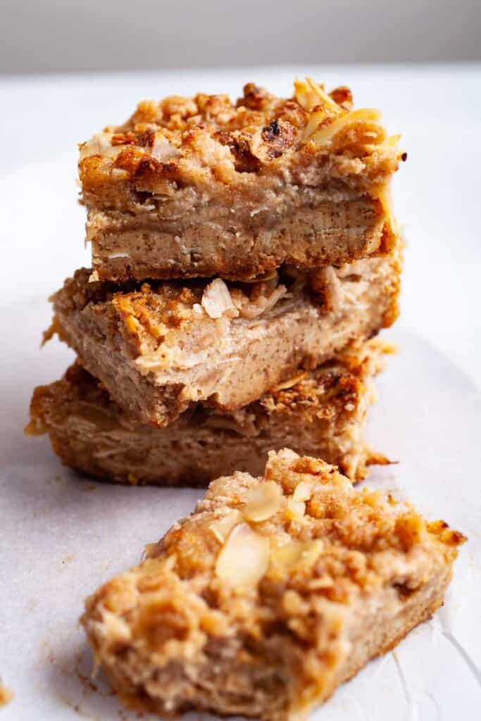 A stack of 3 almond flour rhubarb cookie bars with another one in teh foreground.