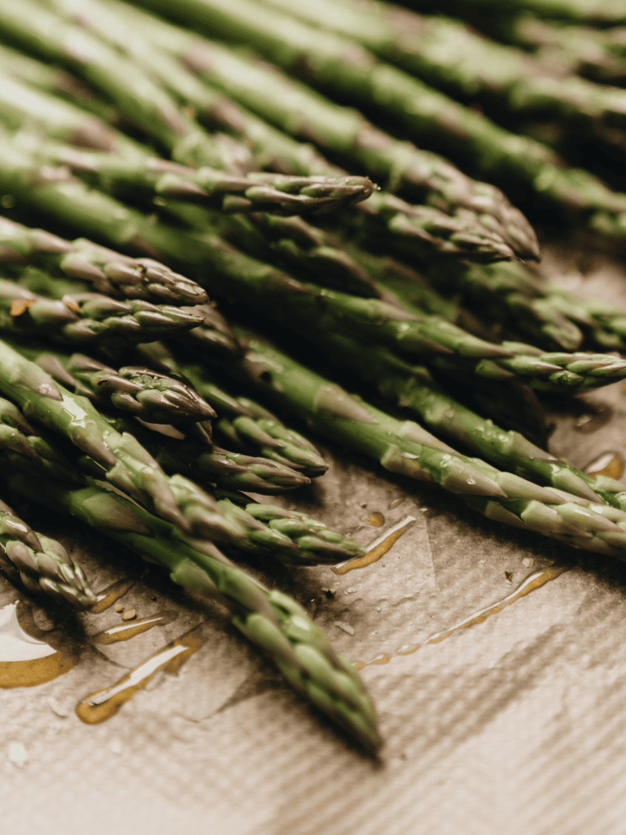 Close up of asparagus stalks tossed with olive oil
