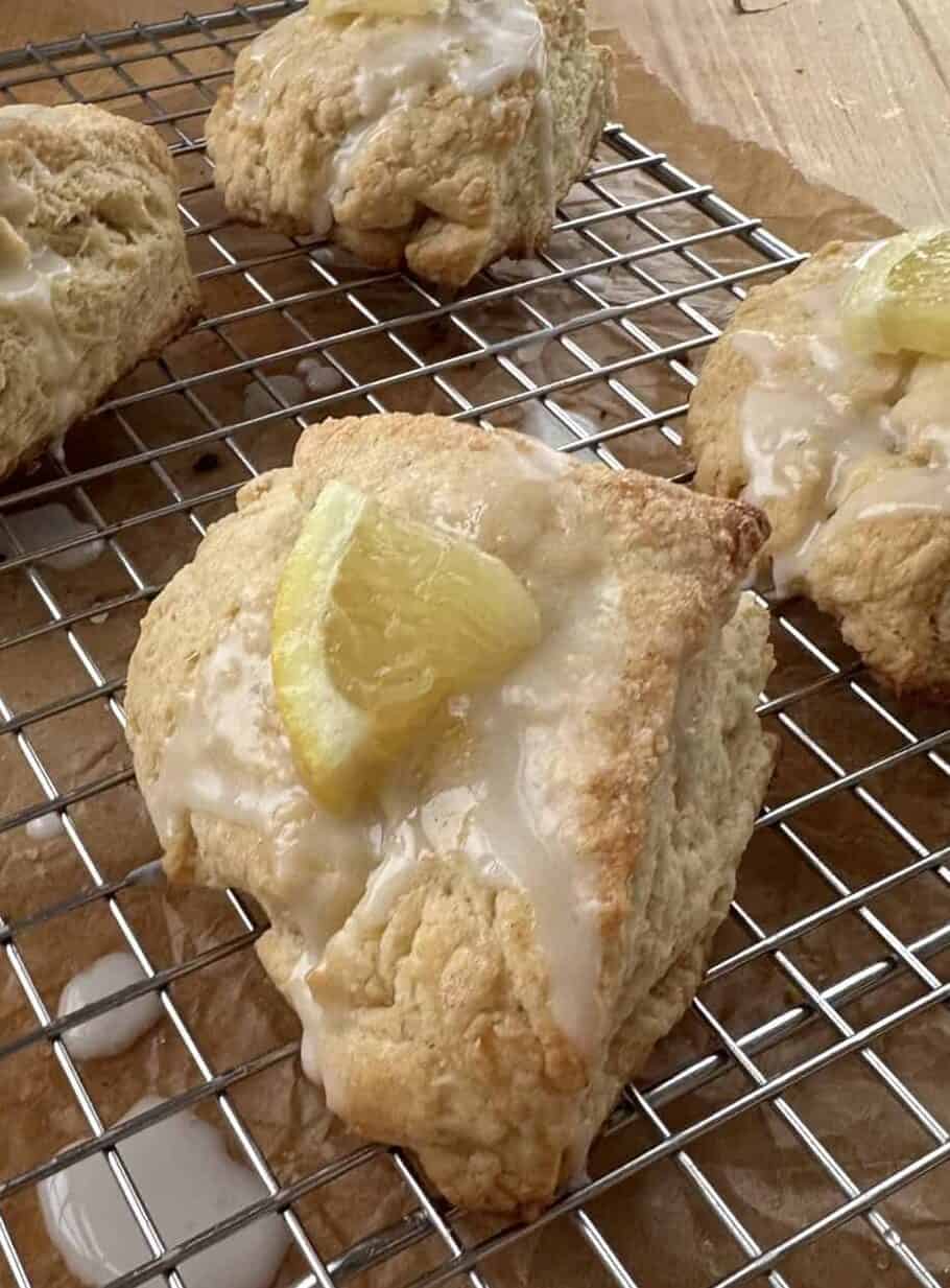 Close up of lemon scones with a lemon wedge on top
