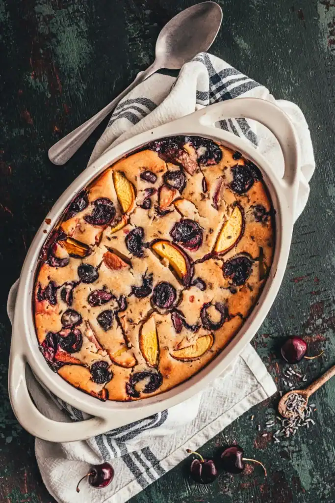 A top down shot of a cobbler with peaches and cherries