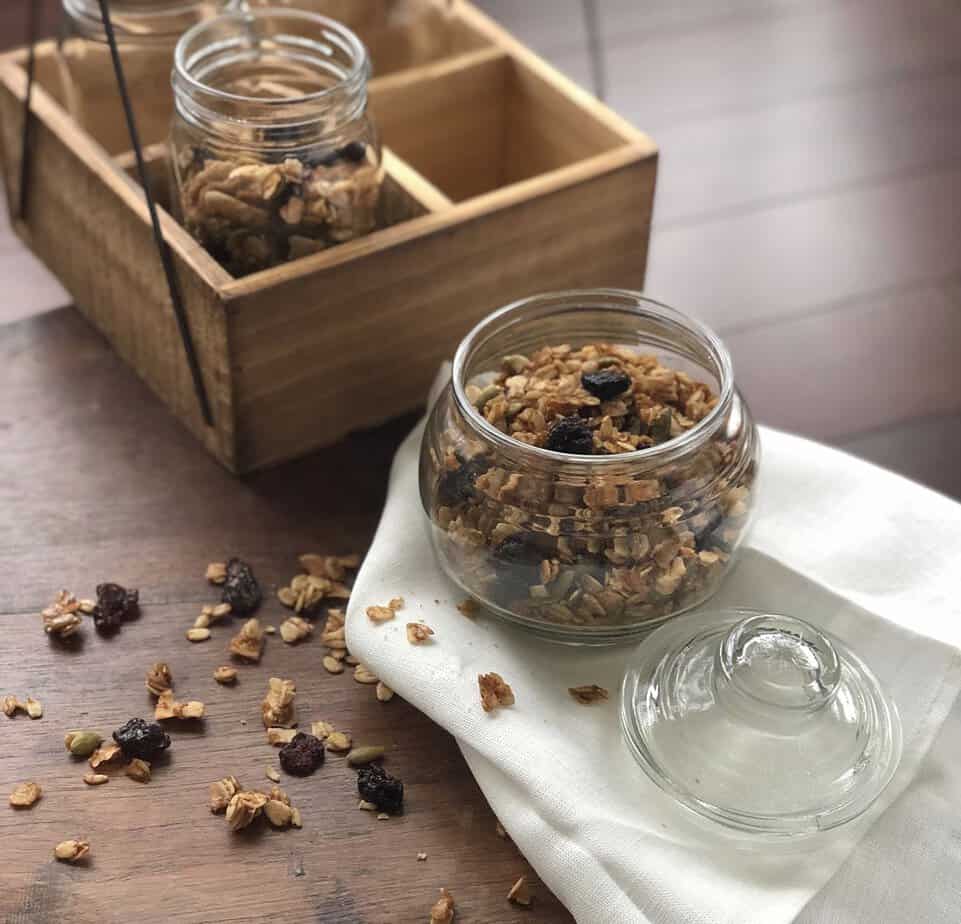 An image of homemade cherry granola in a glass canister