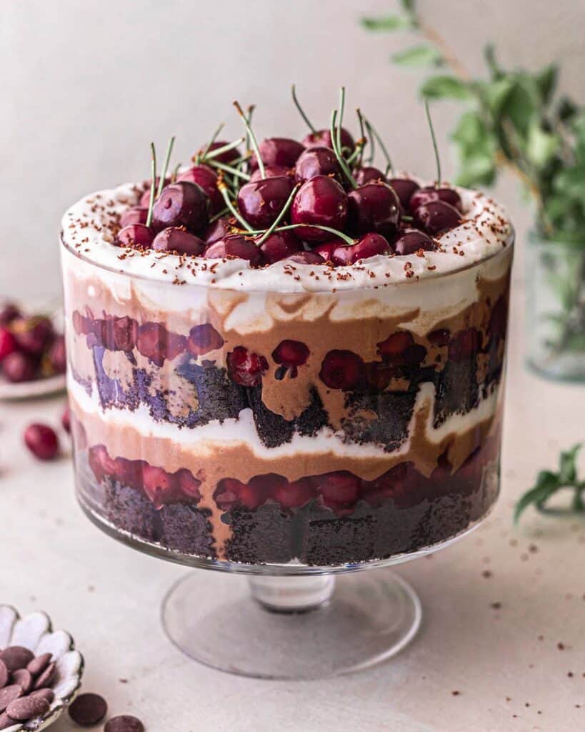 A black forest trifle topped with loads of fresh cherries