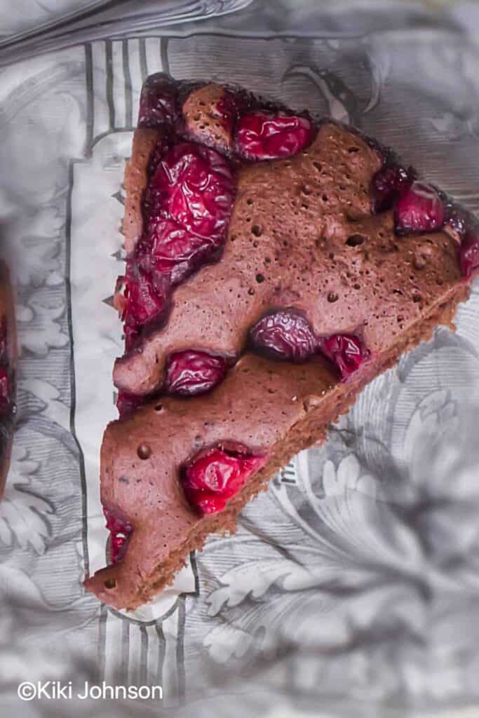 A top down shit of a slice of a vegan cherry chocolate cake